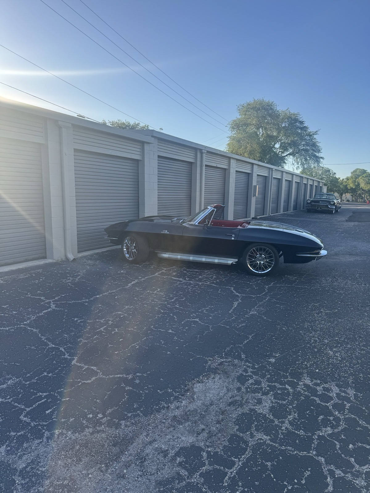 Classic Corvette convertible next to drive-up storage units Clearwater